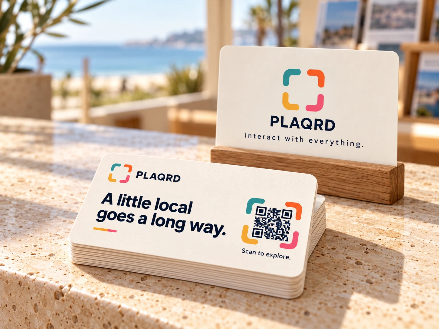 Ivory PLAQRD cards on a reception counter with a small oak card holder